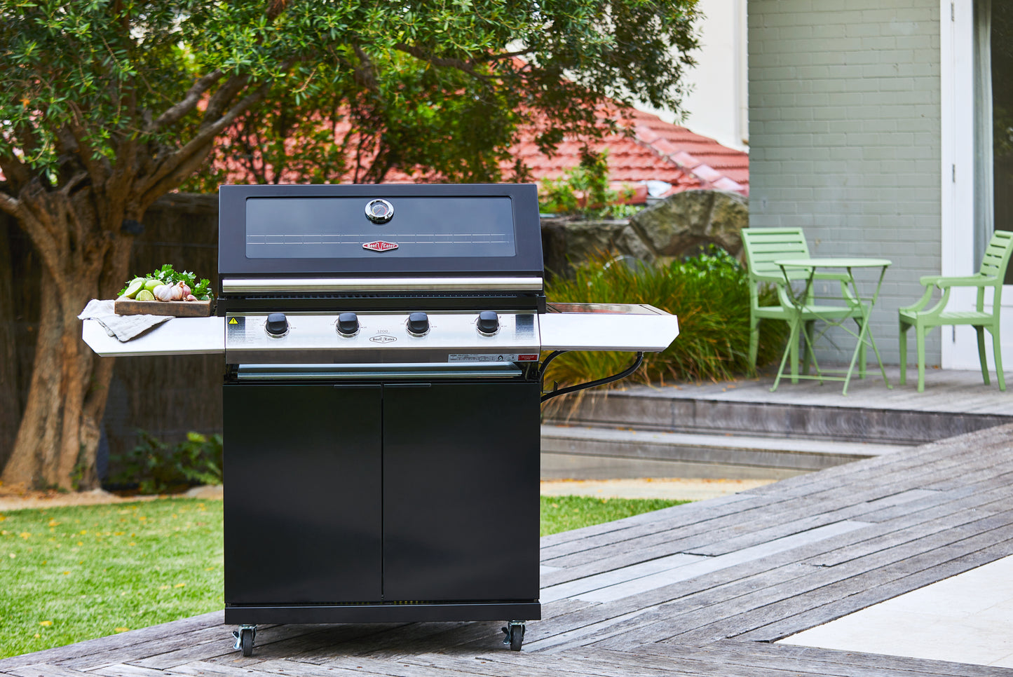 Beefeater 1200E Series 4 Burner Gas BBQ with Trolley and Side Burner in a garden deck with the hood closed